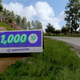 A bonus board on the side of the road in Forza Horizon 5 on Xbox Series X.